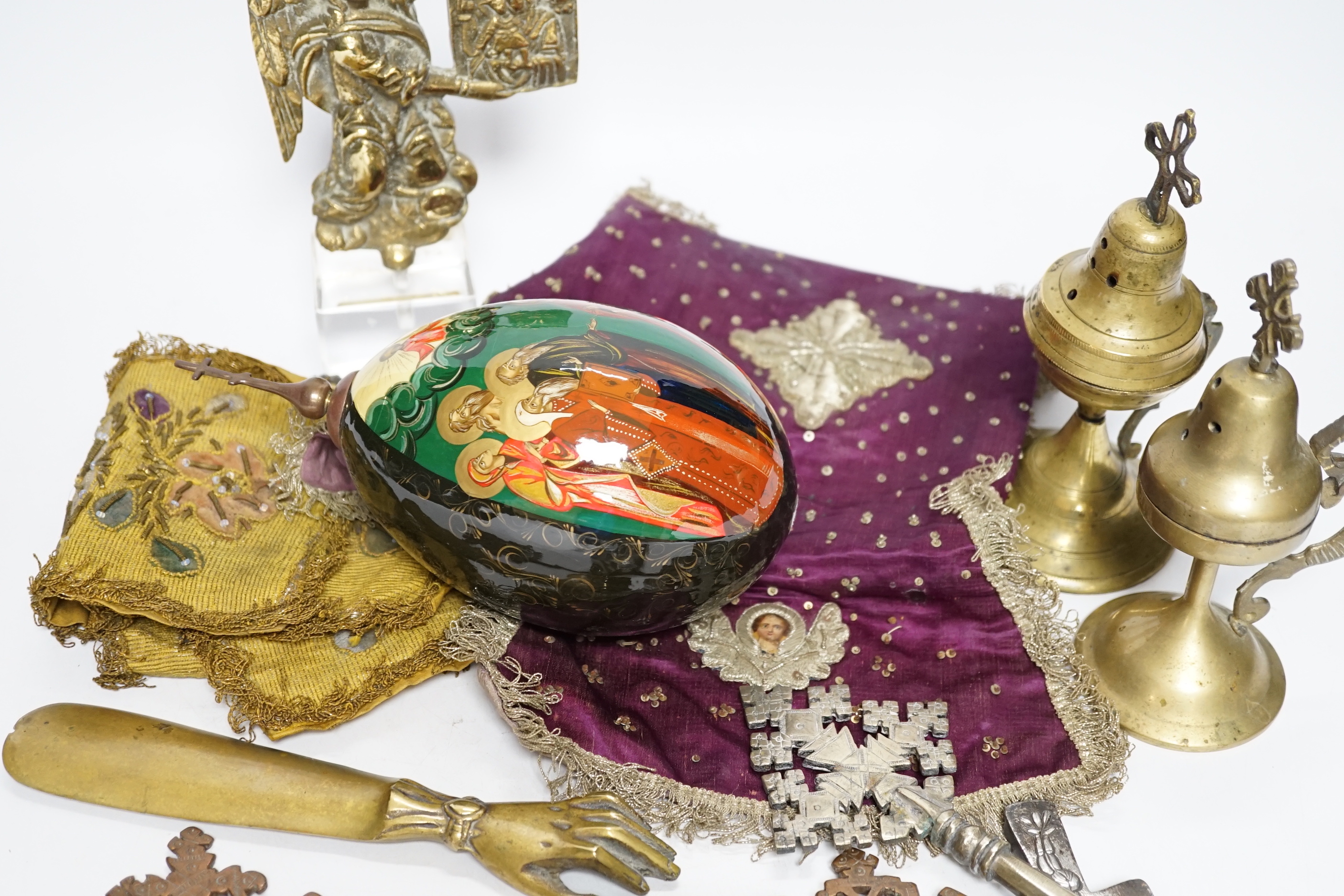 Coptic Christian items including crosses, censers, a brass angel, two embroidered chalice covers, a large painted egg with orthodox cross on the top, a lidded patten box, etc. (11)